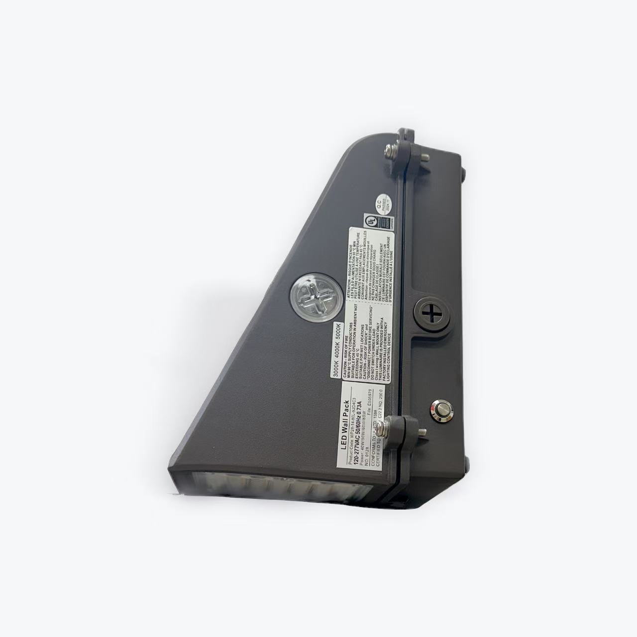 Close-up of the WP28 series Full Cutoff Wall Pack with Emergency Battery Backup, triangular and dark grey, featuring a transparent side, labels, screws, and a plus-shaped knob for adjustments against a light grey background.